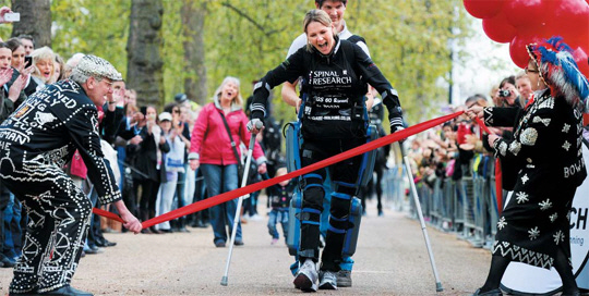 하지마비 장애인 클레어 로마스가 재활 외골격 로봇 ‘리워크’를 입고 마라톤을 완주하고 있다.