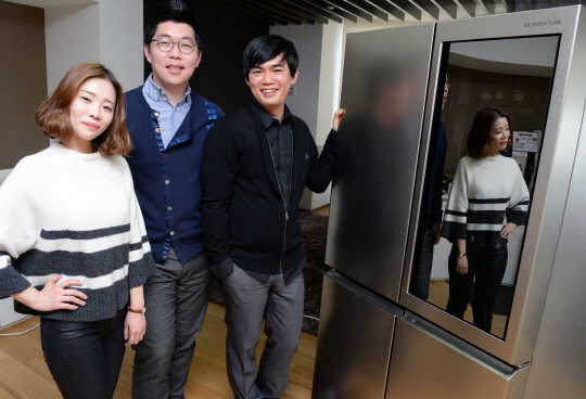 LG 시그니처 냉장고 개발 주역인 이항복(오른쪽부터) 수석, 김민섭 선임, 고소연 주임이 제품을 배경으로 활짝 웃고 있다.    /사진제공=LG전자