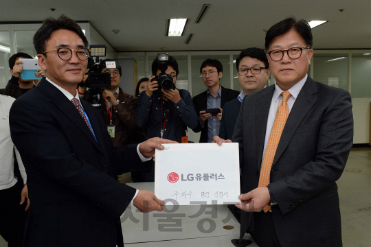 미래창조과학부의  주파수 경매를 위한 신청서 접수 마감일인 18일 오후 LGU+ 박형일 (오른쪽) 상무등 실무진들이 신청서를 미래부 최승만(왼쪽) 주파수할당팀장 에게 전달하고 있다./이호재기자.