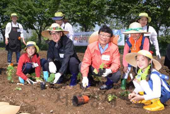 농림축산식품부가 지난 7일 서울 강동구 강일텃밭에서 개최한 ‘꿈틀 어린이 텃밭학교’ 개교식에서 이준식(앞줄 왼쪽 두번째) 사회부총리 겸 교육부 장관과 이동필 농림축산식품부 장관이 참가 학생들과 함께 채소 모종을 옮겨 심고 있다. 이날 교장으로 부임한 이동필 장관은 오는 11월 초까지 초등학생 50명 및 그 가족들과 함께 방학기간을 제외한 매주 토요일 20주간의 프로그램을 운영, 텃밭을 가꾸며 어린이들에게 꿈을 심어줄 계획이다.   /사진제공=농림축산식품부