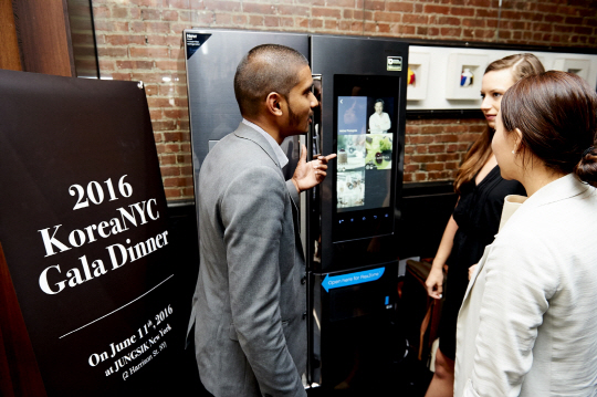 미국 뉴욕에서 열리는 ‘월드베스트 50 레스토랑’의 사전행사로 11일(현지시간) 열린 ‘코리아 NYC 디너’의 참석자들이 ‘삼성 패밀리허브’ 냉장고와 관련 레시피를 살펴보고 있다. /사진제공=삼성전자