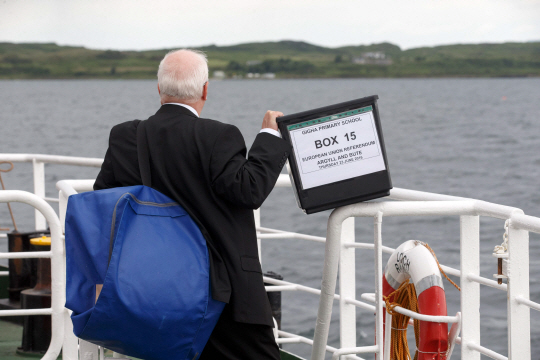 Argyll and Bute Counting Officer Charles Reppke takes the EU Referendum ballot box for the Isle of Gigha over on the Loch Ranza ferry from Tayinloan, off the west coast of Scotland on June 21, 2016.     There are 122 votes on Gigha and voting will take place in the local primary school, Gigha Primary.    / AFP PHOTO / Robert Perry      <저작권자(c) 연합뉴스, 무단 전재-재배포 금지>