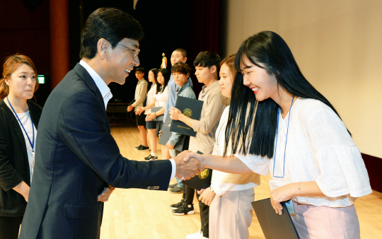 안희정(사진 왼쪽) 충남도지사가 장학생으로 선발된 대학생에게 장학증서를 전달하고 악수를 나누고 있다. 사진제공=충남도