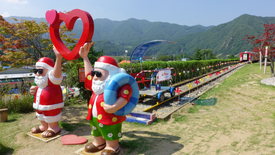 여름분위기 복장을 한 산타할아버지 모형으로 포토존을 만들어 놓은 경북 봉화 산타마을. 사진제공=코레일