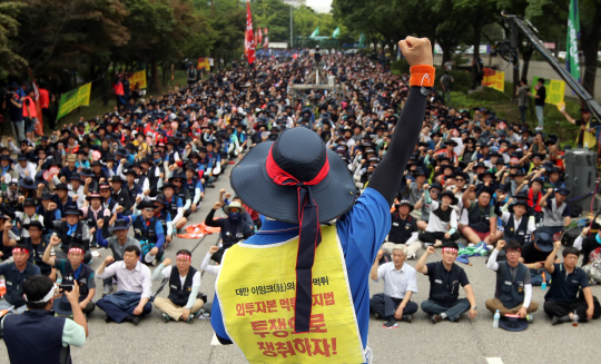 전국금속노동조합이 총파업에 나선 22일 서울 영등포구 여의도 산업은행 본사 앞에서 ‘금속노조 총파업 투쟁대회’에 참가한 조합원들이 구호를 외치고 있다.   /연합뉴스