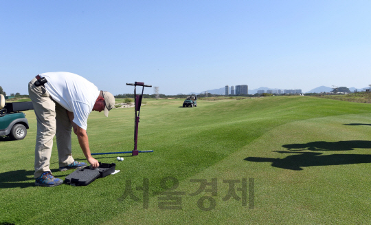 리우올림픽 관계자가 28일(한국시간) 올림픽 골프코스에서 그린을 정비하고 있다. 올림픽 골프는 다음달 11일부터 열린다. /리우데자네이루=이호재기자