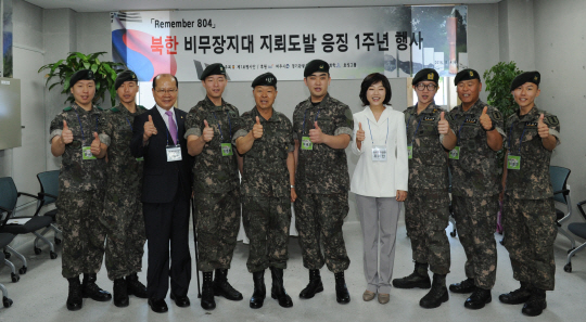 장준규 육군 참모총장이 4일 경기도 파주시 임진각에서 열린 북한 비무장지대(DMZ) 지뢰도발 1주기 기념행사에서 수색대원 및 참석내빈과 기념촬영하고 있다. 왼쪽부터 문시준 중위, 정교성 중사, 새누리당 이종명 의원, 김정원 하사, 장 총장, 하재헌 하사, 조윤선 전 여성가족부 장관, 박준호 예비역 병장, 박선일 원사, 이형민 하사. /파주=연합뉴스