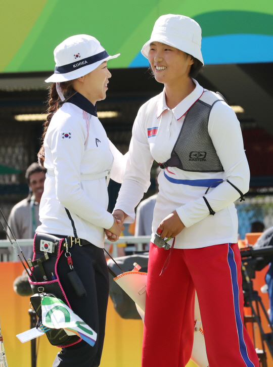 양궁대표팀 장혜진 선수가 11일 (현지시간) 브라질 리우데자네이루 마라카낭 삼보드로무 양궁장에서 열린 2016 리우올림픽 양궁 여자 개인전 16강 경기에서 북한 강은주와 대결을 펼친후 인사를 나누고 있다./리우데자네이루=올림픽사진공동취재단