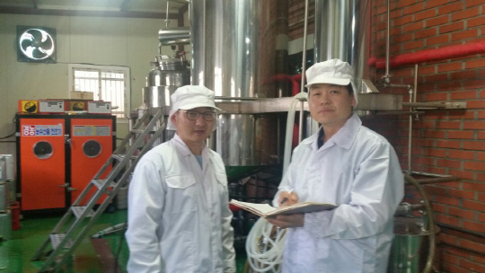 지성훈(오른쪽) 금산 인삼식품특화지원센터장이 한국인삼명가 공장에서 1인 기업인의 경영애로 사항을 들으면서 메모를 하고 있다. /서정명기자