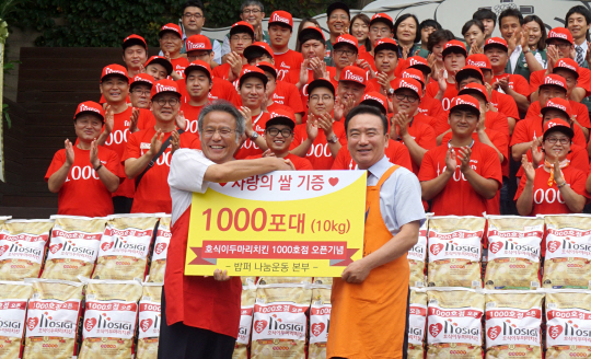 최호식 호식이두마리치킨 회장(오른쪽)이 1000호 가맹점 돌파를 기념해 지난 18일 밥퍼나눔운동본부에 ‘사랑의 쌀’ 1,000포를 기증하고 있다.