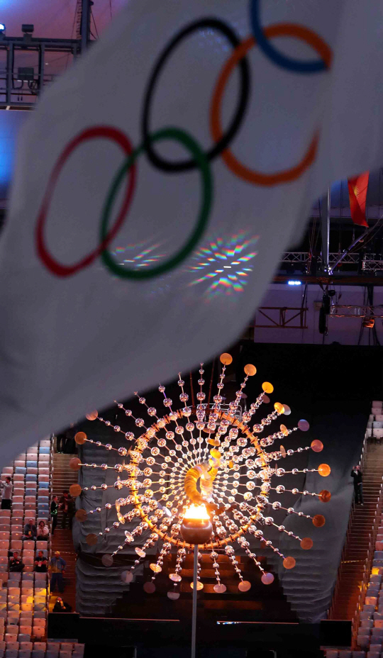 21일 오후(현지시간) 브라질 리우데자네이루 마라카낭 주경기장에서 열린 2016 리우올림픽 폐막식에서 성화위로 오륜기가 펄럭이고 있다. /리우데자네이루=올림픽사진공동취재단