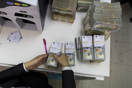 캄보디아 프놈펜의 아클레다 은행 직원이 미국 달러를 정리하고 있다./자료=블룸버그