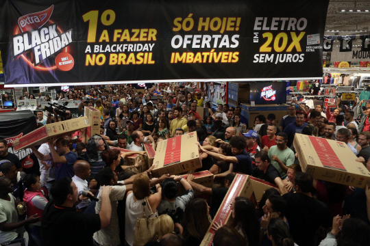 25일(현지시간) 브라질 상파울루의 한 가전 매장에서 사람들이 블랙프라이데이를 맞아 대폭 할인된 TV를 구입하려고 서로 손을 내밀고 있다. /상파울루=신화연합뉴스