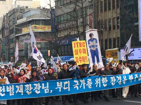 손석희 JTBC 보도부문 사장의 사진을 걸고 나온 보수단체 집회 참가자들./이종호기자