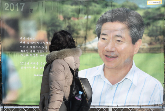 봉하마을 노무현 대통령 묘역을 찾은 시민이 노 전 대통령 사진을 바라보고 있다. /연합뉴스
