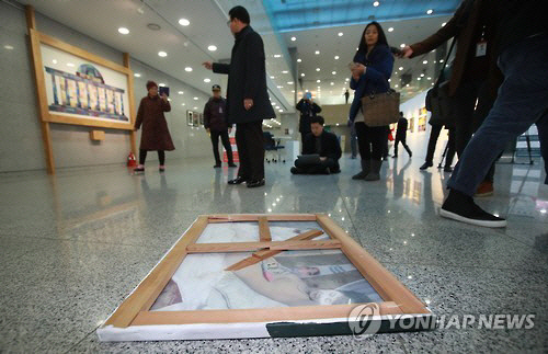 24일 오후 국회 의원회관 1층 로비에 전시된 박 대통령 풍자 그림이 훼손된 채 바닥에 뒹굴고 있다. /연합뉴스
