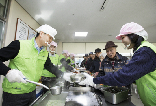 박용상(왼쪽 첫번째) LS산전 경영관리본부장(부사장)이 31일 경기 안양시 노인종합복지관에서 신입사원들과 함께 어르신들에게 떡국을 배식하고 있다. /사진제공=LS산전