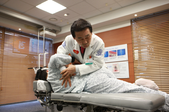 자생한방병원 한의사가 허리·어깨 통증 환자에게 추나요법을 실시하고 있다. /사진제공=자생한방병원