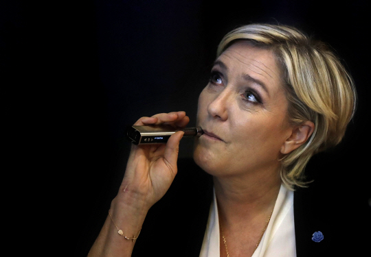 French far-right presidential candidate Marine Le Pen, smokes an electronic cigarette before she starts her press conference, in Beirut, Lebanon, Tuesday, Feb. 21, 2017. Le Pen refused to go into a meeting with Lebanons grand mufti after his aides asked her to wear a headscarf. Le Pen has been on a three-day visit to Lebanon this week and has met senior officials. She was scheduled to meet Grand Sunni Muslim Mufti Sheikh Abdel-Latif Derian but shortly after she arrived at his office, one of his 