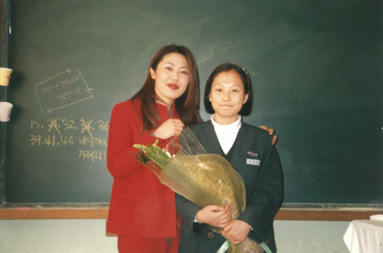모범생으로 중학교를 졸업하던 날 담임선생님과 기념 촬영을 하고 있는 서숙연 대표의 모습.
