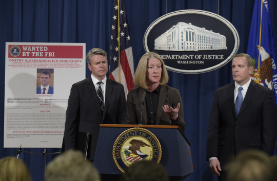 Acting Assistant Attorney General Mary McCord, center, accompanied by U.S. Attorney for the Northern District Brian Stretch, left, and FBI Executive Director Paul Abbate, speaks during a news conference at the Justice Department in Washington, Wednesday, March 15, 2017. The Justice Department announced charges against four defendants, including two officers of Russian security services, for a mega data breach at Yahoo. (AP Photo/Susan Walsh)      <저작권자(c) 연합뉴스, 무단 전재-재배포 금지&g