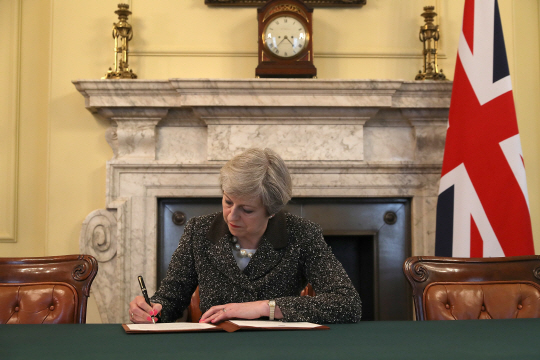테리사 메이 영국 총리가 28일(현지시간) 런던 총리관저에서 유렵연합(EU) 탈퇴 통보문에 서명하고 있다. /런던=AFP연합뉴스