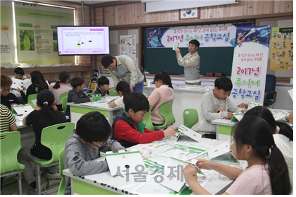 효성이 지난 10일 창원 내동초등학교에서 실시한 주니어 공학교실에서 강사로 나선 효성 직원들의 설명을 따라 학생들이 변압기 모형을 만들고 있다. /사진제공=효성