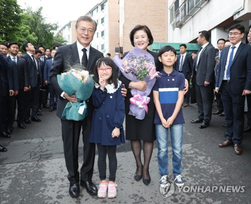 문재인 대통령과 부인 김정숙 여사가 10일 오전 서울시 서대문구 홍은동 자택을 나서며 주민들의 축하를 받고 있다/연합뉴스