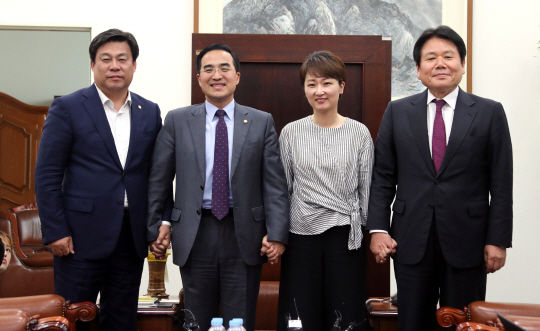 여야 원내수석부대표들이 22일 오후 국회 운영위원장실에서 회동을 하기 앞서 손을 잡고 포즈를 취하고 있다. /연합뉴스