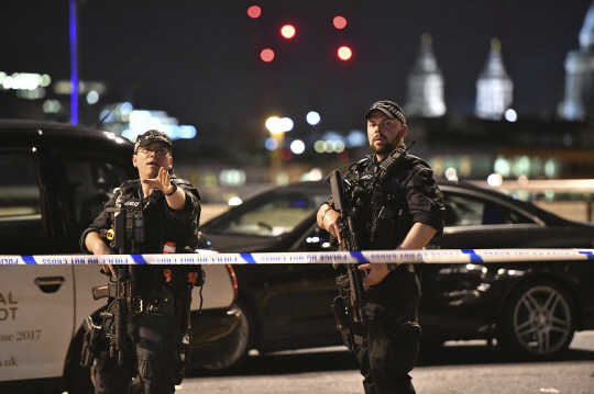 3일(현지시간) 밤 영국 런던 시내 런던 브리지에서 일어난 테러 직후 무장 경찰이 현장에서 경계근무를 서고 있다. 이번 테러 사건으로 현재까지 7명이 사망했고 48명이 병원에서 치료를 받고 있는 것으로 알려졌다./AP=연합뉴스