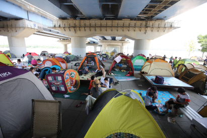 서울 낮 기온이 32도 까지 오른 18일 시민들이 서울 여의도 한강시민공원 다리 밑에서 텐트를 치고 더위를 피하고 있다. /연합뉴스