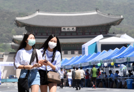 황금연휴 마지막 날, 중국발 황사로 인한 미세먼지가 전국을 뒤덮은 7일 서울 광화문광장에서 학생들이 마스크를 착용한 채 길을 걷고 있다./서울경제DB