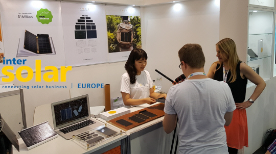 지난해 6월 ‘인터솔라 유럽 2016’에 참여했을 당시 장성은(왼쪽) 요크 대표가 전시장을 찾은 취재진에게 솔라페이퍼의 원리를 설명하고 있다. /사진제공=요크