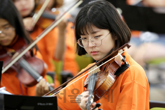 한화그룹이 8일부터 3일간 무주 태권도원에서 ‘한화청소년오케스트라 여름캠프’를 진행했다.  캠프에 참여한 한 학생이 자신의 악기 연주에 몰입하고 있다. /사진제공=한화그룹