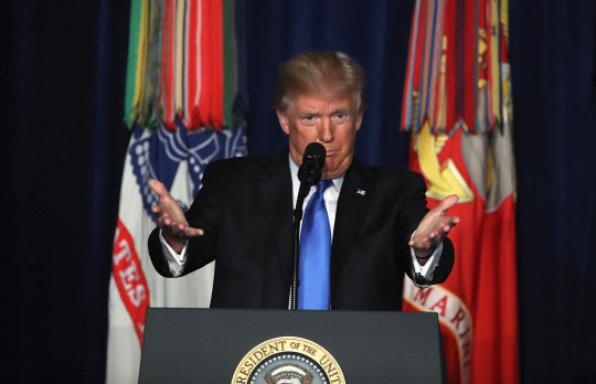 도널드 트럼프 미국 대통령이 21일(현지시간) 미 버지니아주 알링턴 포트마이어 기지에서 전국으로 생중계되는 TV연설에서 아프가니스탄에 대한 적극적인 군사 개입 의지를 밝히고 있다. “탈레반의 아프가니스탄 장악을 저지할 것”이라는 이날 연설은 한때 아프간 주둔 미군의 철수까지 검토했던 트럼프 행정부의 대외정책이 개입주의로 일대 전환한다는 선언으로 받아들여지고 있다. 다만 이날 트럼프 대통령은 당초 예상과 달리 구체적인 병력 증파 규모나 일정을 밝히지는 않았다. /알링턴=AFP연합뉴스