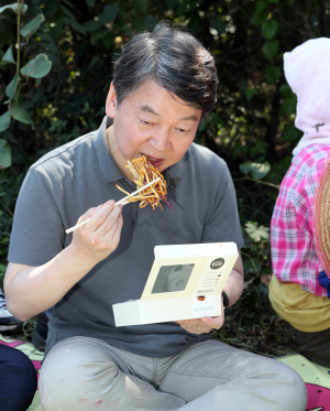 안철수 국민의당 대표가 14일 오전 전북 김제시 공덕면 제말리 밭에서 고구마를 수확한 후 새참으로 고구마 튀김을 먹고 있다./연합뉴스