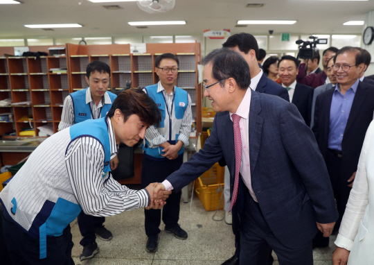 홍준표(오른쪽) 자유한국당 대표가 26일 오전 서울 송파우체국을 찾아 직원들과 인사하고 있다./연합뉴스