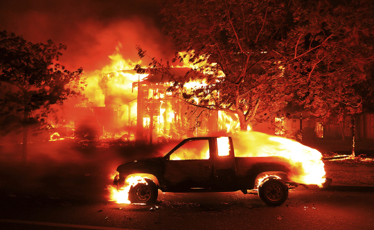 9일(현지시간) 미국 캘리포니아 주 산타로사시 북부 지역인 커피 파크 지역에 산불이 시내까지 들이닥쳐 식당과 가게가 전소되고 주민이 대피했다./AP㎜