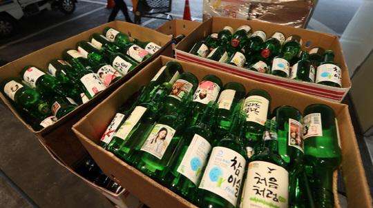 서울의 한 마트 근처에서 박스에 담긴 하이트진로 소주 빈병들이 놓여 있다. 하이트진로는 13일 노사간 임단협 단체교섭이 결렬됨에 따른 파업으로 생산이 중단된다고 공시했다. /연합뉴스