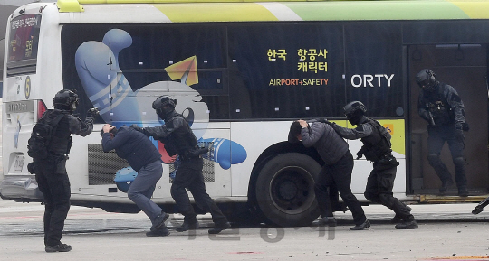 1일 오후 김포공항 국제선 계류장에서 실시된 김포공항 항공기 사고 위기대응 및 대테러 종합훈련에서 특공대원들이 무장테러범에게 피랍된 버스로 진입 테러범들을 끌어내리고 있다./이호재기자.