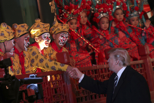 도널드 트럼프 미국 대통령이 8일(현지시간) 베이징 자금성 창음각에서 경극 공연을 관람한 뒤 배우들과 악수하고 있다. /베이징=AP연합뉴스
