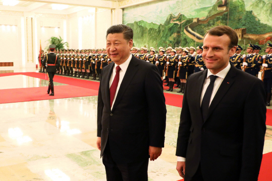 시진핑(왼쪽) 중국 국가주석과 에마뉘엘 마크롱(오른쪽) 프랑스 대통령이 9일 중국 베이징 인민대회당에서 정상회담을 하기에 앞서 중국 군대의 사열을 받고 있다.    /베이징=AP연합뉴스