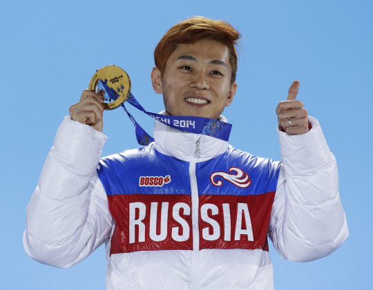 FILE - In this Feb. 15, 2014, file photo, men‘s 1,000-meter short track speedskating gold medalist Viktor Ahn, of Russia, gestures while holding his medal during the medals ceremony at the Winter Olympics in Sochi, Russia. Ahn returns to skate in his birth country at the Olympics after competing as a Russian in the 2016 Sochi Olympics. His nationality has taken twists and turns. He won his first four Olympic medals for South Korea in the 2006 Turin Games when he was known as Ahn-Hyun Soo. After