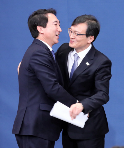 김의겸(오른쪽) 청와대 대변인과 박수현 전 대변인이 2일 오후 춘추관에서 브리핑을 마친 뒤 포옹하고 있다.      /연합뉴스