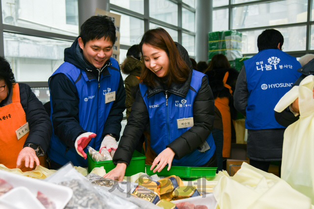 9일 효성 임직원들이 서울 중구 이화여자외국어고등학교 체육관에서 열린 ‘2018 사랑의 떡국 나누기’에 참여해 취약계층에게 전달할 떡과 소고기 등 떡국거리가 담긴 바구니를 만들고 있다. / 사진제공=효성