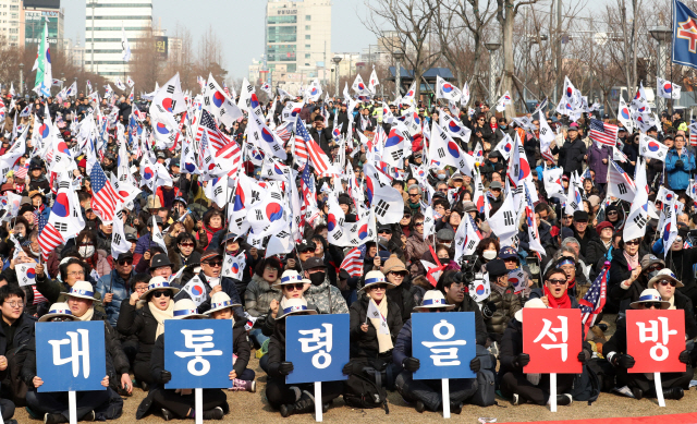 대한애국당과 박근혜 전 대통령 무죄석방 1,000만 서명운동본부 주최로 10일 부산 송상현광장에서 열린 태극기 집회에서 참가자들이 태극기와 미국 성조기를 흔들고 있다.    /부산=연합뉴스