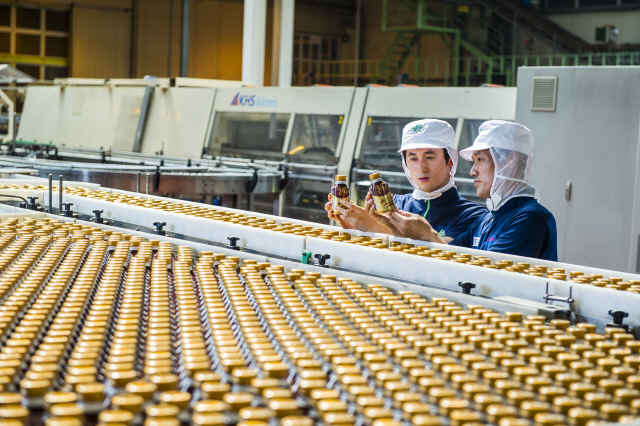 롯데칠성음료 대전 공장에서 직원들이 완성된 칸타타 제품을 살펴보고 있다. /사진제공=롯데칠성음료