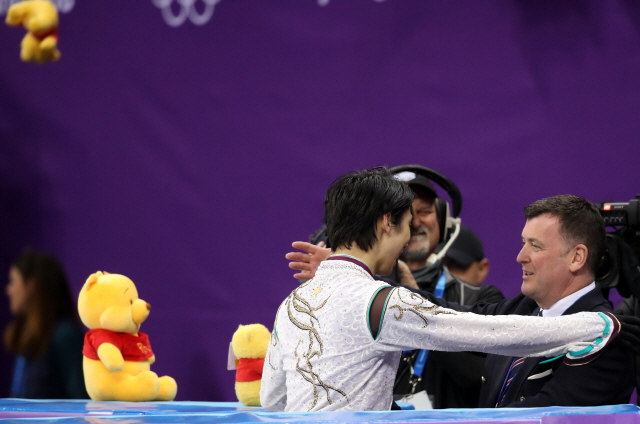 브라이언 오서(오른쪽) 코치가 17일 평창올림픽 피겨 남자 싱글 연기를 모두 마친 제자 하뉴 유즈루를 안아주고 있다. /연합뉴스