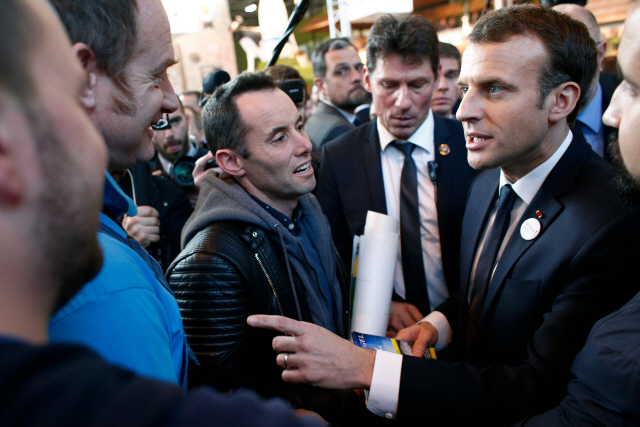 French President Emmanuel Macron (R) speaks with farmers as he visits the 55th International Agriculture Fair (Salon de l‘Agriculture) at the Porte de Versailles exhibition center in Paris, on February 24, 2018. / AFP PHOTO / POOL / Thibault Camus      <저작권자(c) 연합뉴스, 무단 전재-재배포 금지>