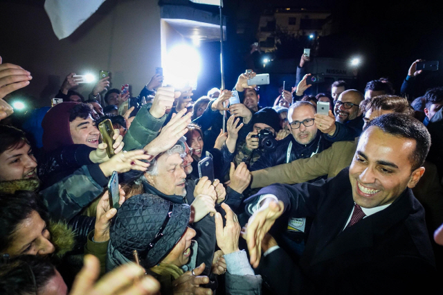 반체제 포퓰리즘 정당으로 불리는 ‘오성운동’의 루이지 디마이오(오른쪽) 대표가 6일(현지시간) 지지자들과 함께 악수를 나누고 있다.  /볼라=EPA연합뉴스